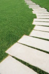 Serpentine pathway stones on a park lawn (concept)