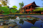 Thai style house reflected in lotus pond,Thailand