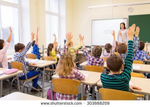 stock-photo-education-elementary-school-learning-and-people-concept-group-of-school-kids-with-teacher-303888209