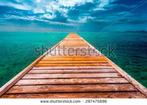 stock-photo-empty-wooden-dock-over-tropical-blue-water-287475896